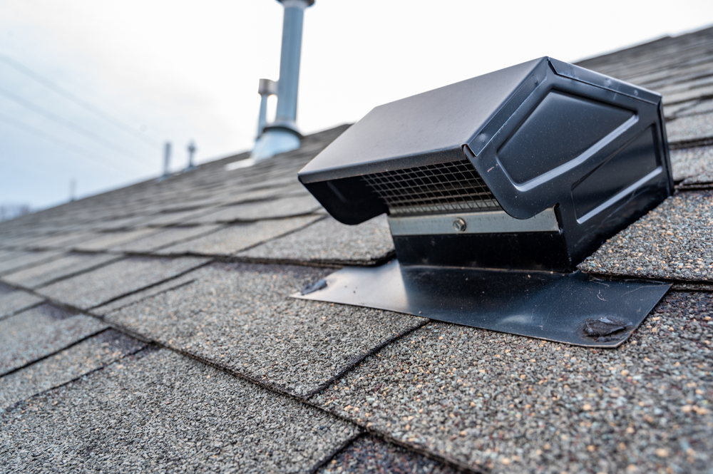 A roof vent that has recently been installed on an asphalt shingle roof