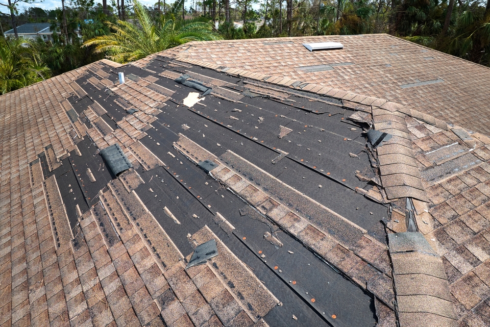 A roof that has been damaged by storm winds and needs repair work